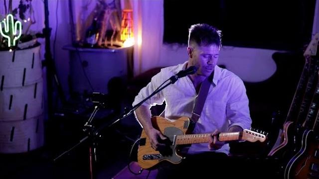 Picture of Billy Fox singing and playing guitar