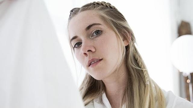 Close-up of Woodes against white curtains