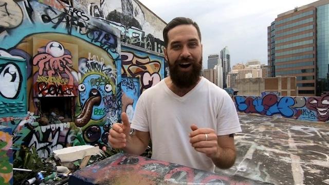 Picture of David Knobel on a graffitied rooftop